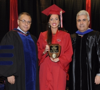 Jeanne Theriot receiving the Fall 2014 Sigred Lanoux Service Award from Dr. Thomas Junk and Dean Ackleh