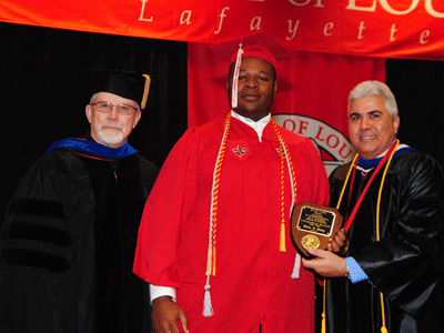 Uwem Sam Ekong receiving the Fall 2015 David R. Andrew Scholar Award from Dr. Jim Etheredge and Dean Ackleh