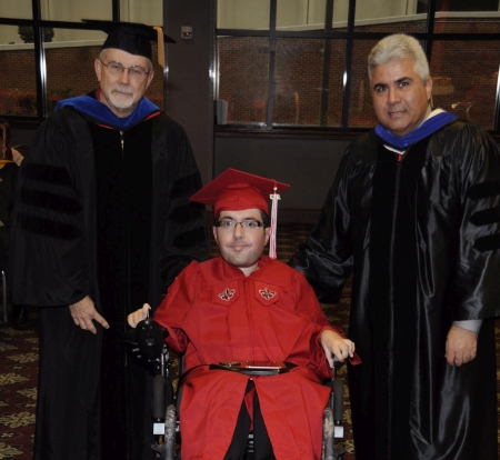 Justin Paul Garrett receiving the Fall 2014 Duane Blumberg Spirit Award from Dr. Jim Etheredge and Dean Ackleh